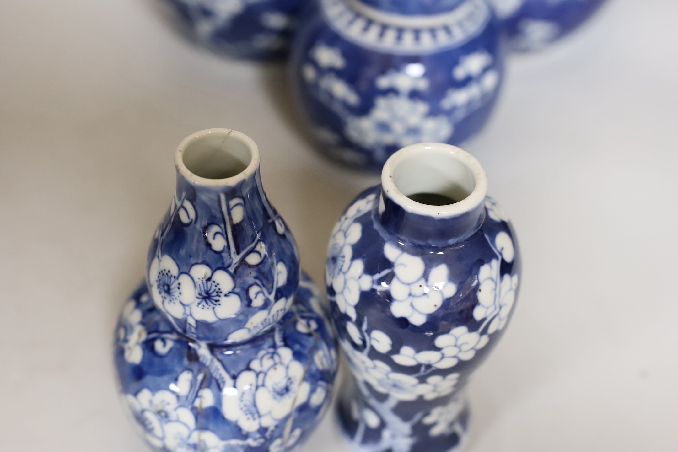 Four Chinese blue and white prunus pattern ginger jars, together with three similar vases. 19th/early 20th century, Tallest 15cm